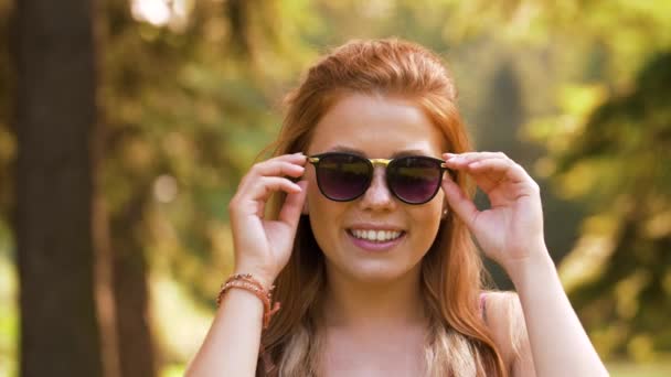 Portrait of redhead teenage girl in summer park — Stock Video
