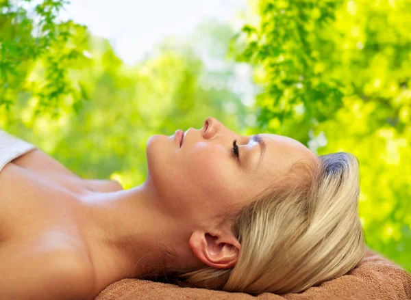 Young woman lying on massage table in spa — Stock Photo, Image