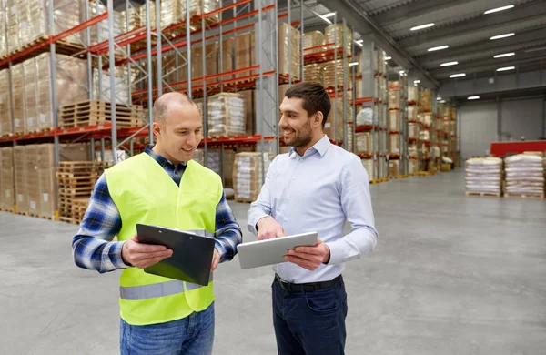 Worker and businessman with tablet pc at warehouse — Stock Photo, Image