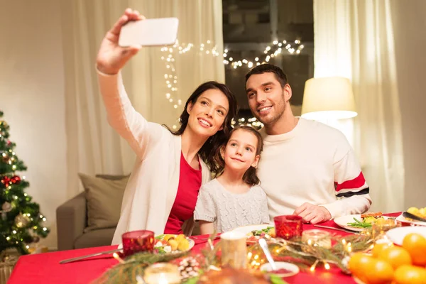 Happy family taking selfie at christmas dinner — Stock Photo, Image