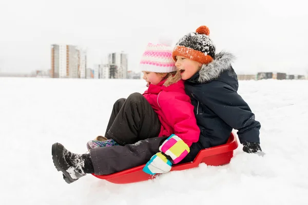 Little kids sliding on sled down hill in winter — Stock Photo, Image