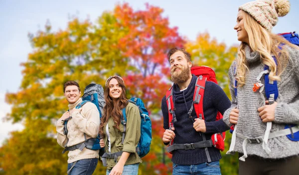 Group of friends with backpacks hiking in autumn — Stock Photo, Image