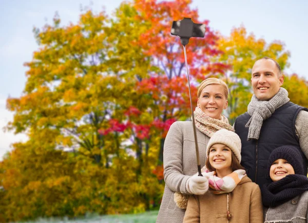 Family taking selfie over autumn park background — Stock Photo, Image