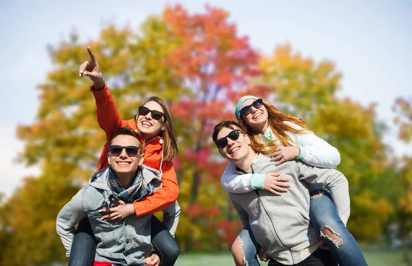 Happy friends in shades having fun in autumn park — Stock Photo, Image