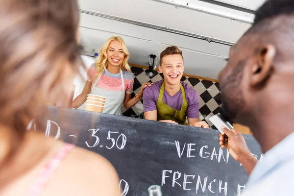 Clienti che danno carta di credito al venditore di camion alimentari — Foto Stock