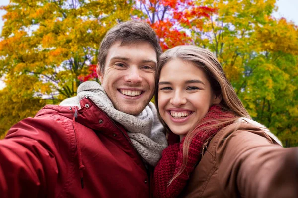 Happy couple taking selfie in autumn Royalty Free Stock Images