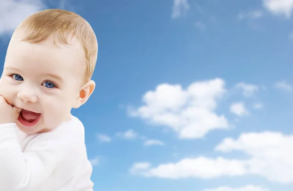 Close up of sweet little baby over sky background — Stock Photo, Image