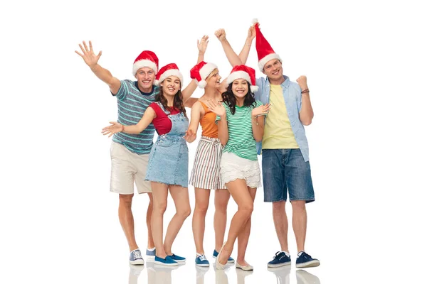Glada vänner i santa hattar över vit bakgrund — Stockfoto