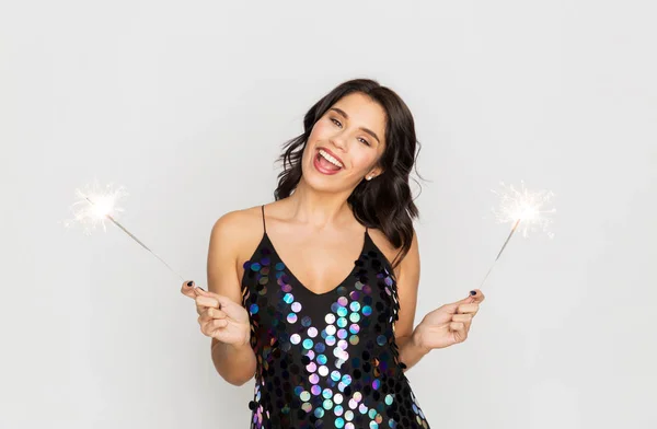 Jovem mulher feliz com sparklers na festa — Fotografia de Stock