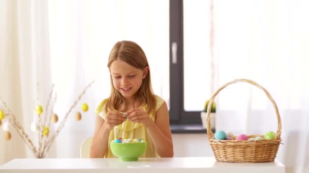 Girl removing wrapper of chocolate easter egg — Stock Video