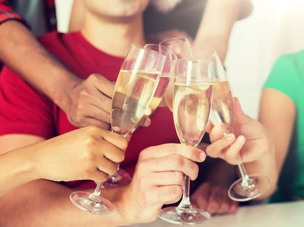 Friends clinking glasses of champagne at party — Stock Photo, Image