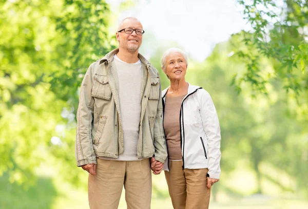 Happy senior couple over green natural background — Stock Photo, Image