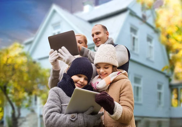 Famiglia con tablet pc sopra casa vivente in autunno — Foto Stock