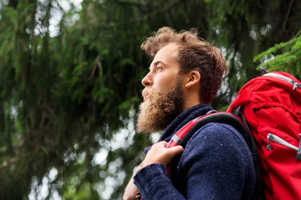 Bearded traveler with backpack in woods — Stock Photo, Image