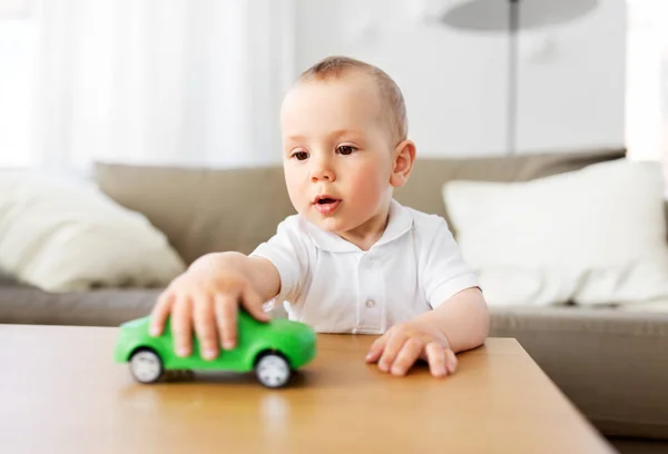 Baby boy playing with toy car at home — Stock Photo, Image