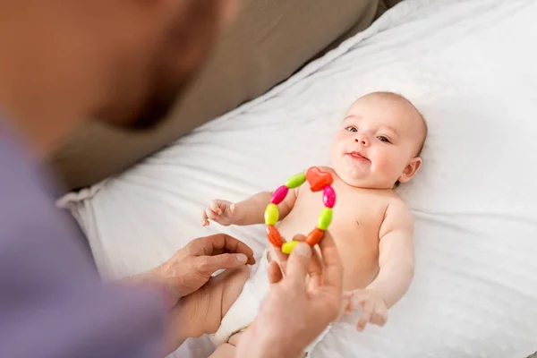 Close up de pai dando chocalho para bebê menina — Fotografia de Stock