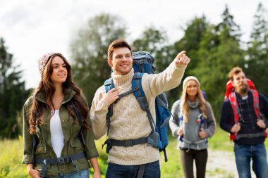 happy friends or travelers with backpacks hiking clipart