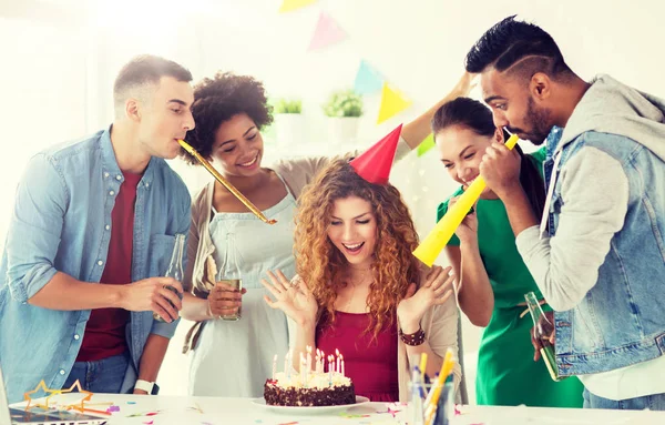 team greeting colleague at office birthday party