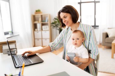 working mother with baby boy and laptop at home clipart
