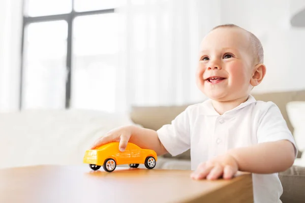 Happy baby boy playing with toy car at home — Stock Photo, Image