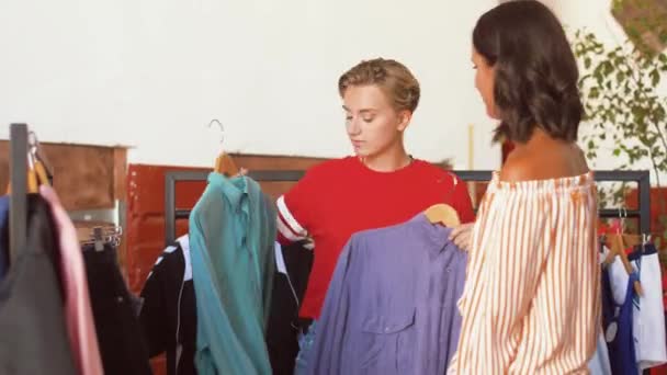 Kvinnor väljer kläder till vintage klädbutik — Stockvideo