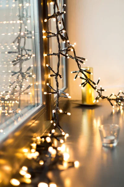 Close up of christmas garland on window sill — Stock Photo, Image