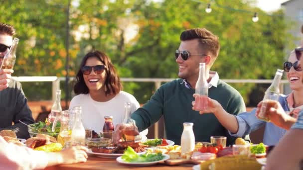 Happy vrienden roosteren dranken op dak feestje — Stockvideo