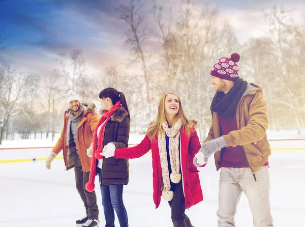 Happy friends on skating rink outdoors — Stock Photo, Image