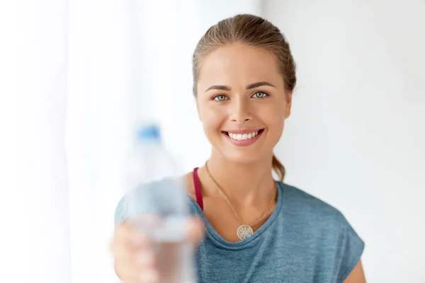 Donna felice che mostra bottiglia d'acqua — Foto Stock