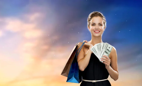 Smiling woman in dress with shopping bags — Stock Photo, Image