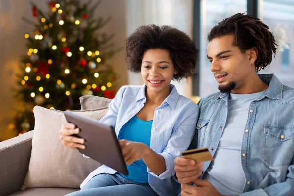 Pareja con tablet pc y tarjeta de crédito en Navidad — Foto de Stock
