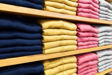 close up of shelves with clothes at clothing store clipart