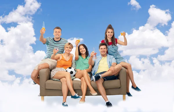 Friends or soccer fans with ball and drinks in sky — Stock Photo, Image