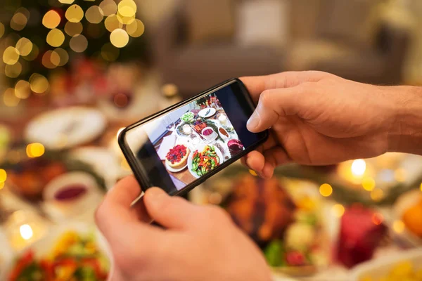 Hands photographing food at christmas dinner — Stock Photo, Image