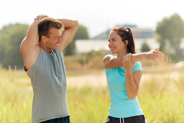 Smiling couple stretching outdoors Stock Image