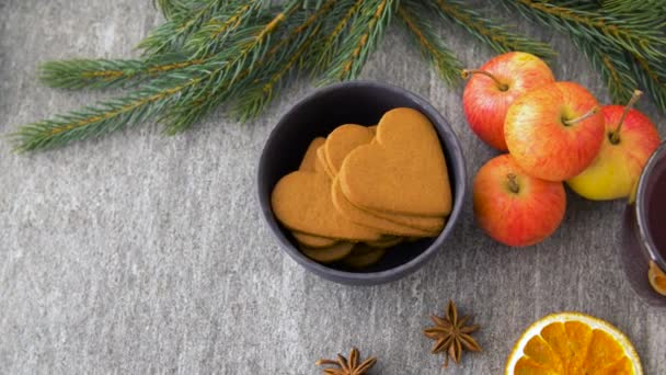 Glass of hot mulled wine, cookies, apples and fir — Stock Video