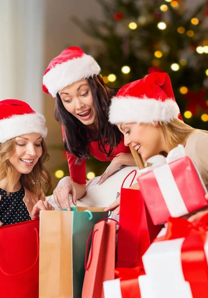 Women in santa hats with gifts on christmas Royalty Free Stock Images