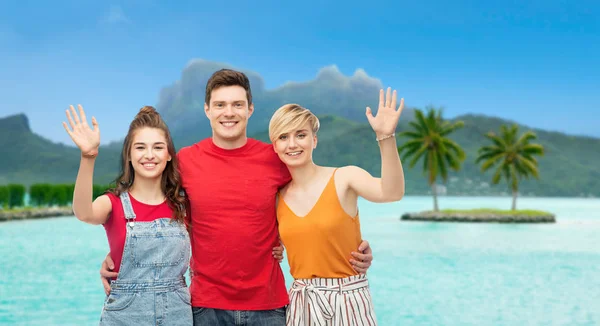 Happy friends hugging over bora bora beach — Stock Photo, Image