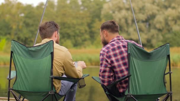 Friends with smartphone fishing on lake — Stock Video