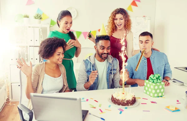 office team greeting colleague at birthday party