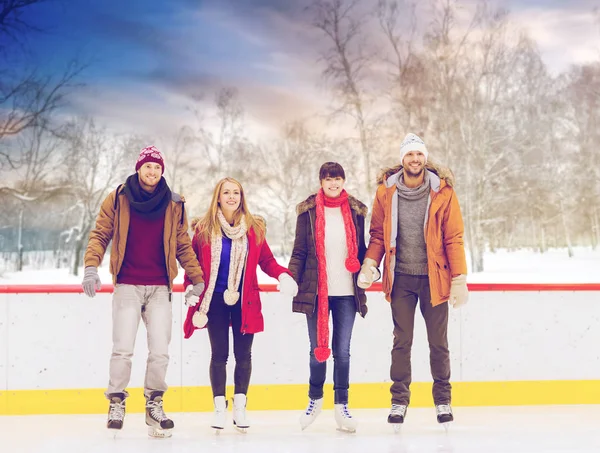 Happy friends on outdoor skating rink — Stock Photo, Image