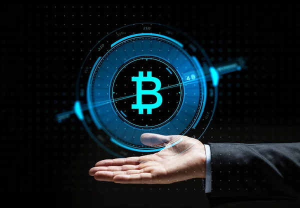 Buisnessman hand with bitcoin hologram — Stock Photo, Image