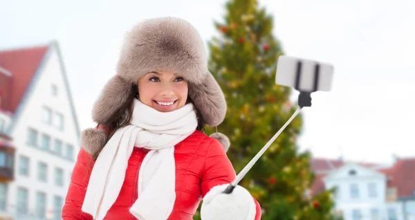 Woman taking selfie over christmas tree — Stock Photo, Image