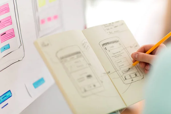 Ui designer with user interface sketch in notebook — Stock Photo, Image