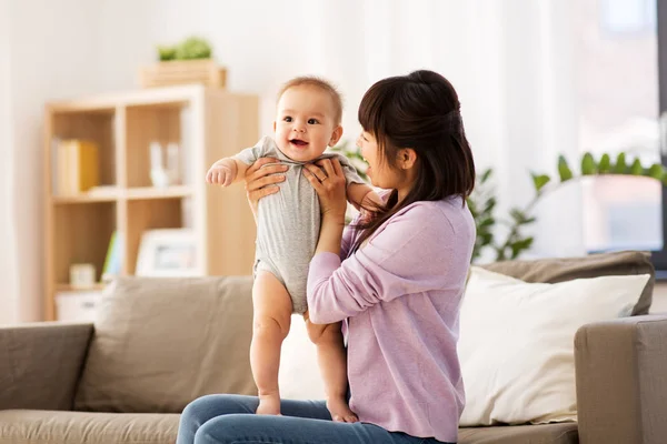 Happy young asian mother with little baby at home — Stock Photo, Image