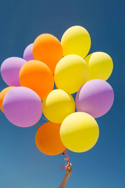 Primer plano de globos de helio de colores en el cielo azul — Foto de Stock