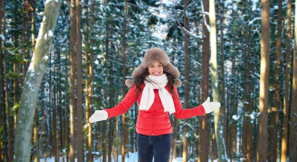 Happy woman in fur hat over winter forest — Stock Photo, Image