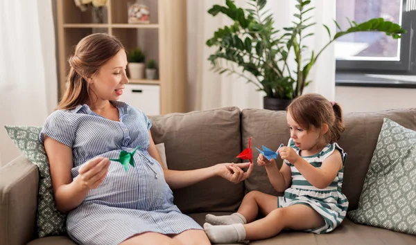 Madre embarazada e hija con origami de grúa —  Fotos de Stock