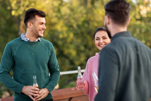 Amis heureux avec des boissons à la fête sur le toit — Photo