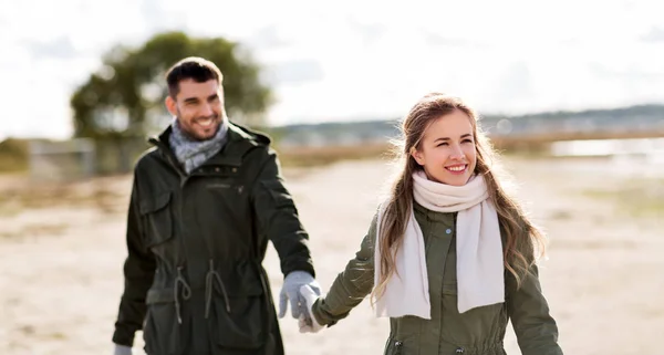 Paar wandelen langs herfst strand — Stockfoto